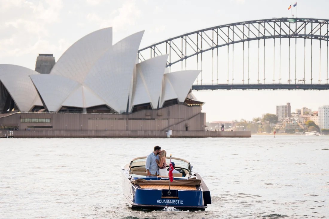 Chelsea and Alex on a boat beside Sydney Opera House