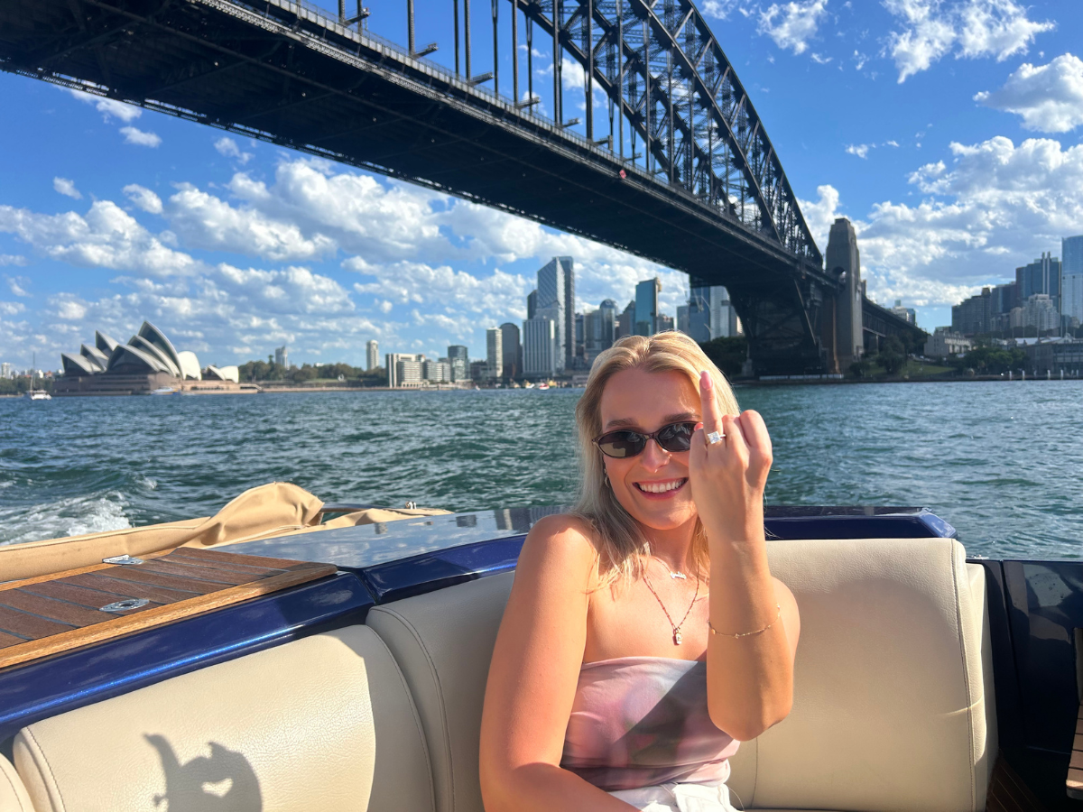 Chelsea showing her engagement ring on Sydney Harbour